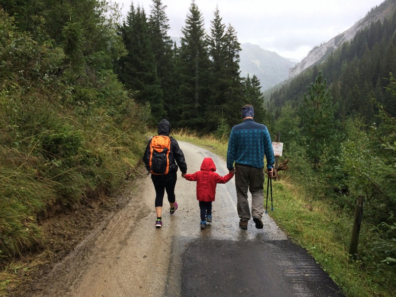 A family walking together along a forest path